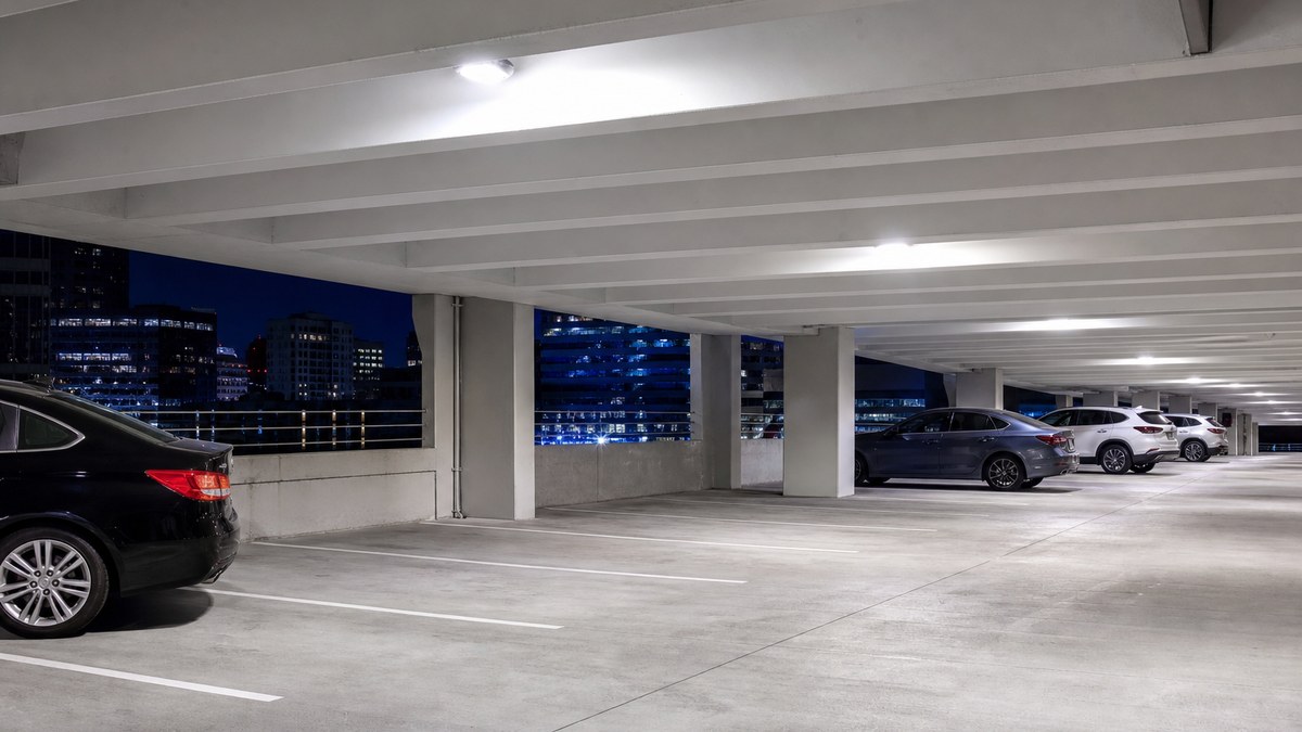 Parking garage LED lighting in Irving TX with bright even light across a multi-level concrete deck at night